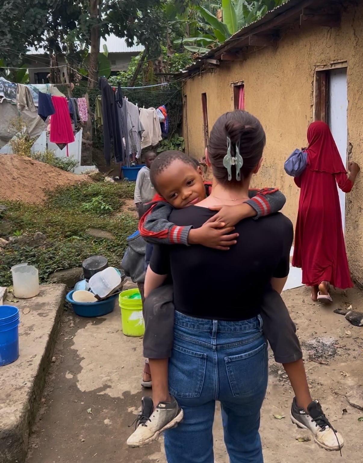Two people greeting one another with a hug.