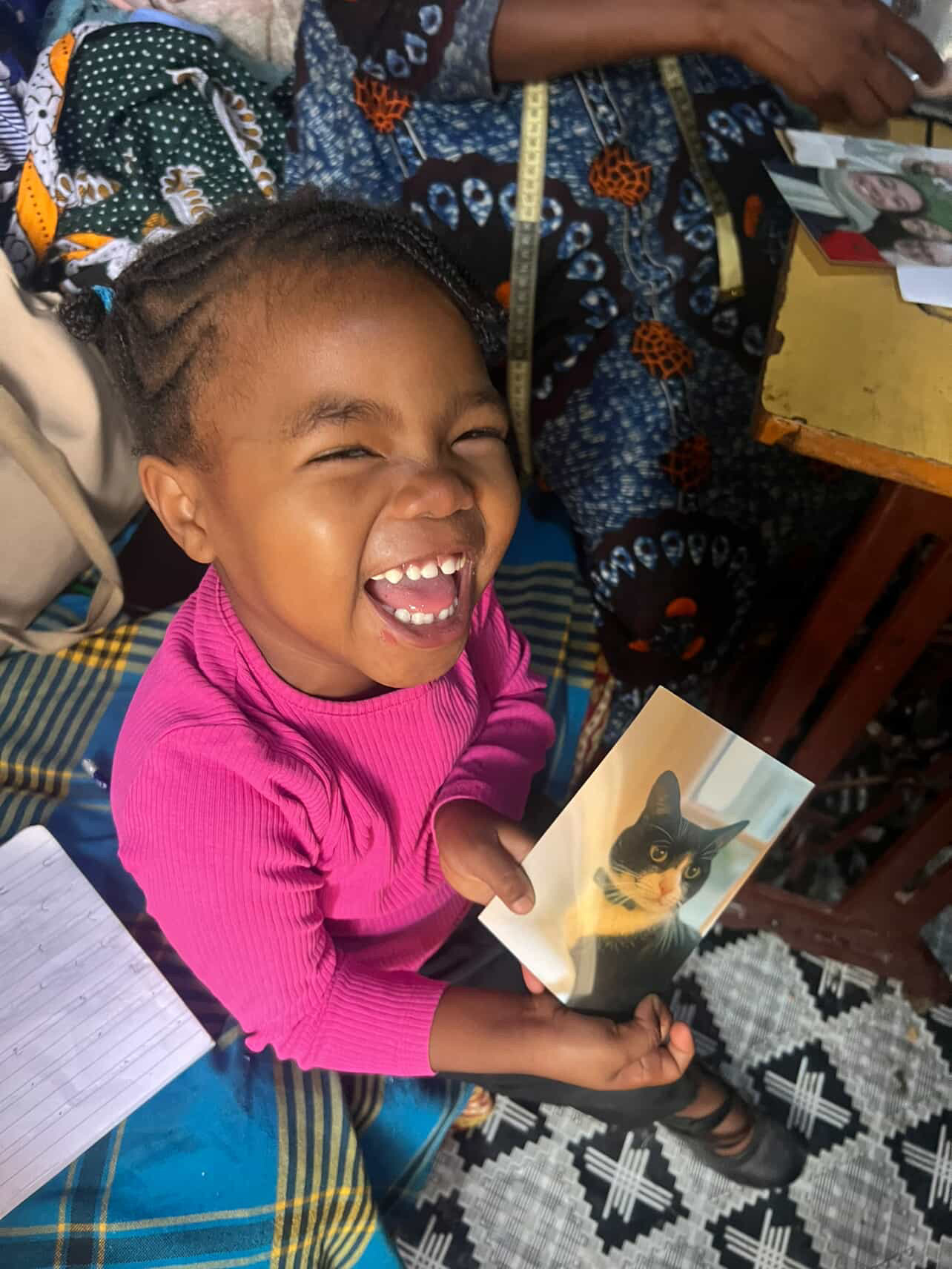 Nurath laughing while holding a card sent by a supporter.